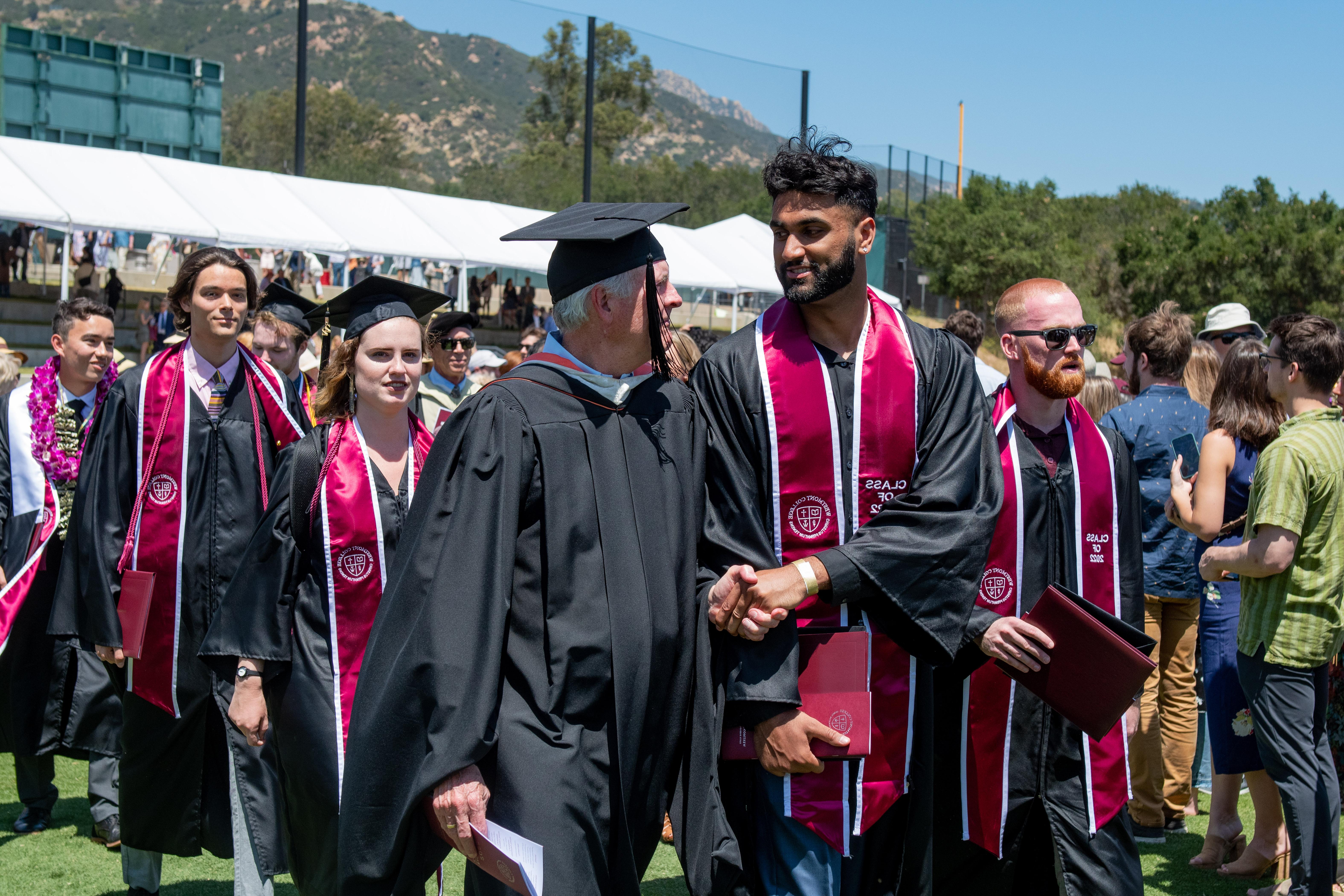 westmont professor and student shaking hands at commencement